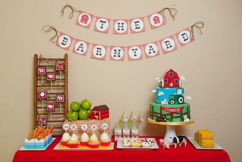 Barnyard-themed birthday cake and dessert table